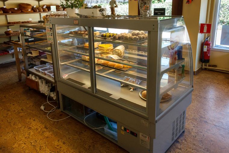 A bakery display counter with cakes and pastries