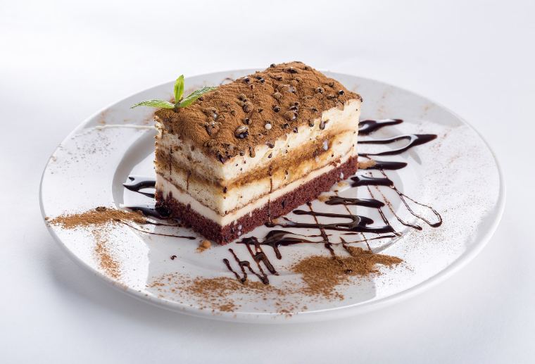 A slice of layered chocolate cake on a plate